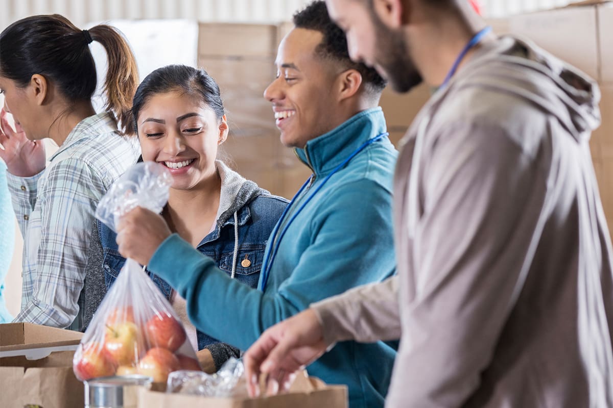 A group of volunteers with a bag of apples