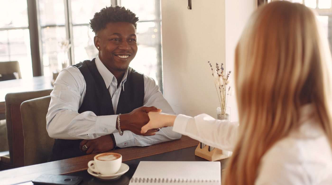 Teen boy shaking hands during a job interview