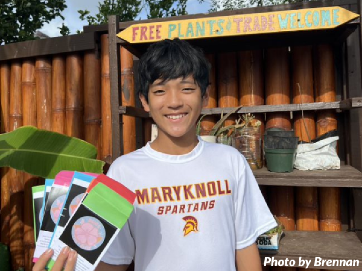 Boy standing with plant seed packets in hand