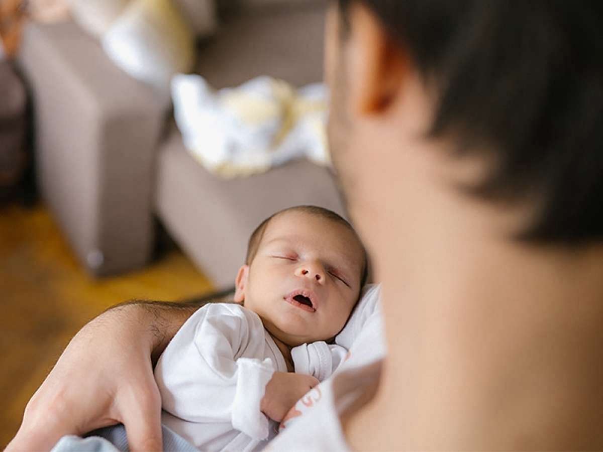 Young dad caring for a baby