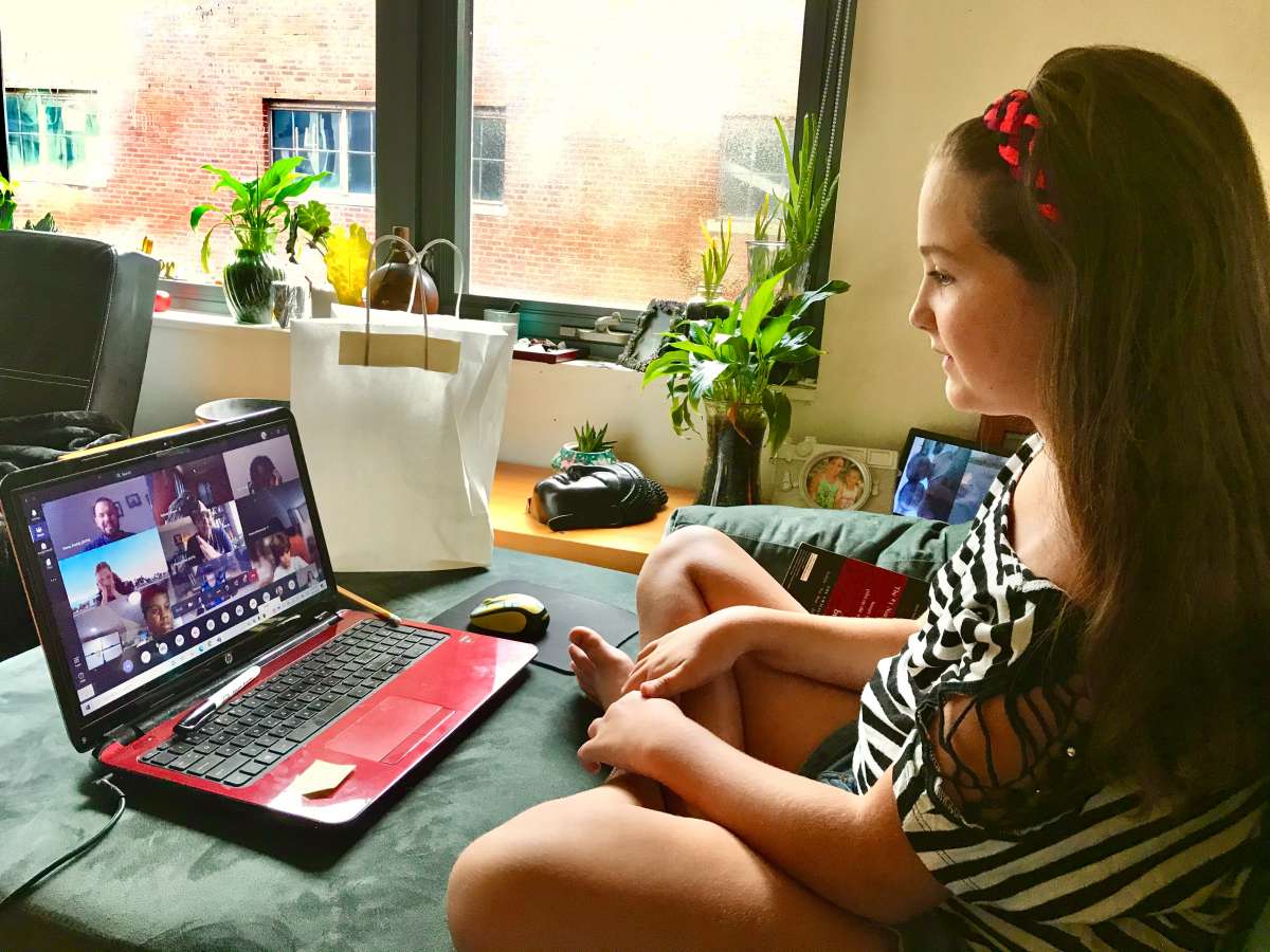 girl taking an online class at home